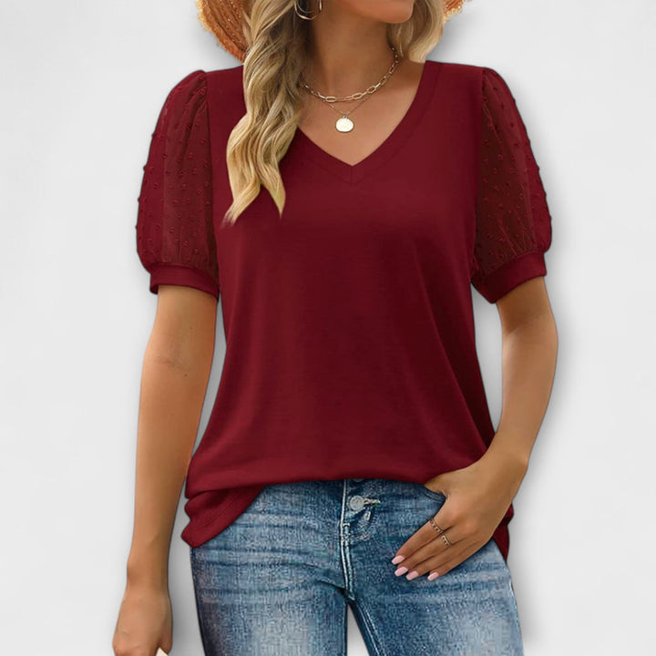 Rema - Top blanco con escote en V y mangas transparentes