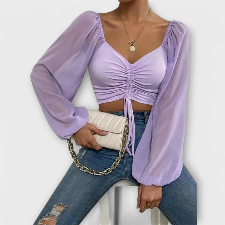 Jacqueline - Blusa color crema con estampado de rostros