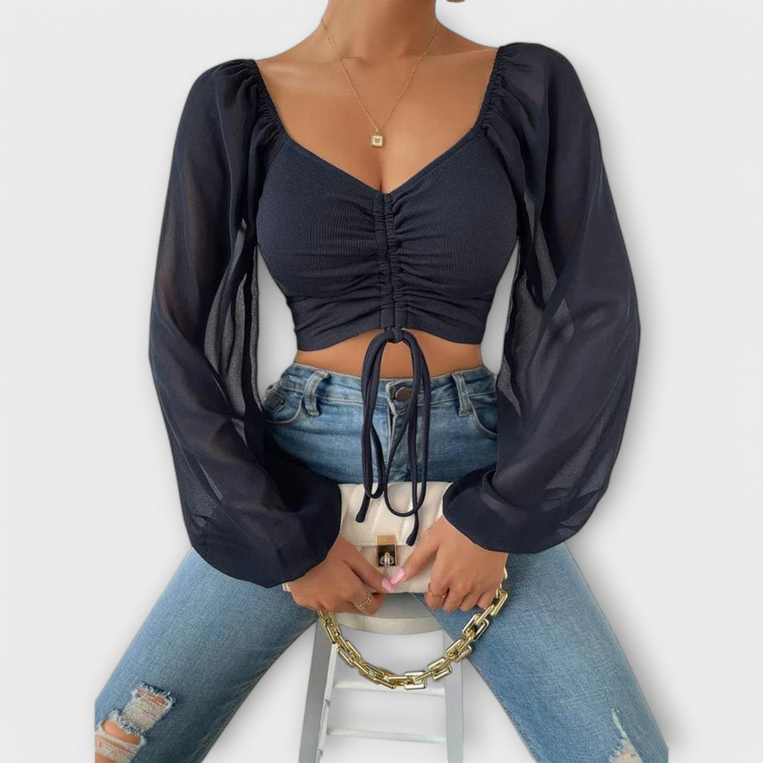 Jacqueline - Blusa color crema con estampado de rostros