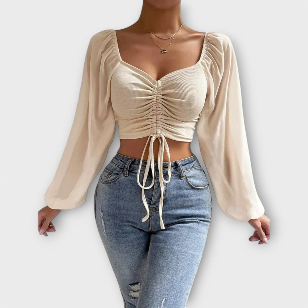 Jacqueline - Blusa color crema con estampado de rostros