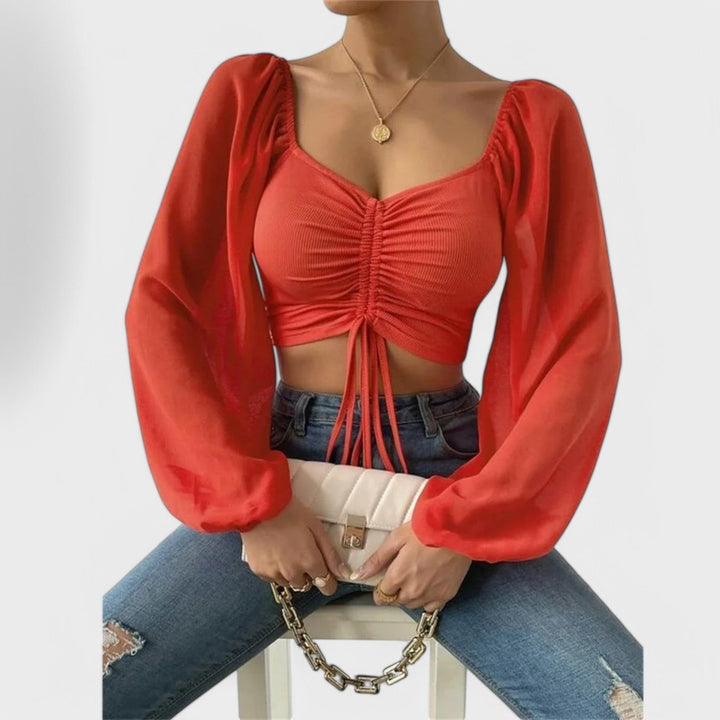 Jacqueline - Blusa color crema con estampado de rostros