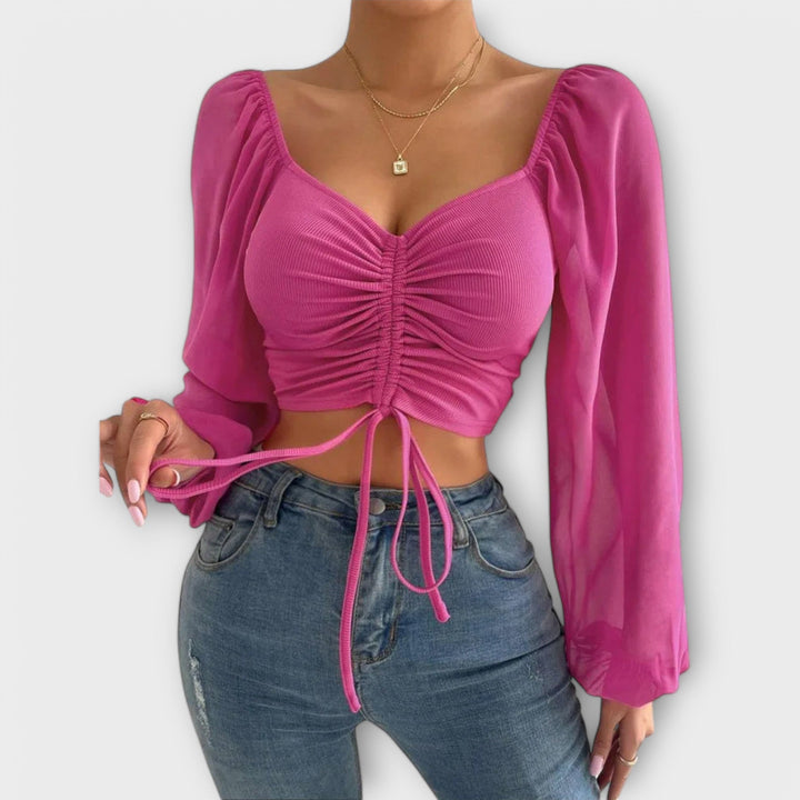 Jacqueline - Blusa color crema con estampado de rostros