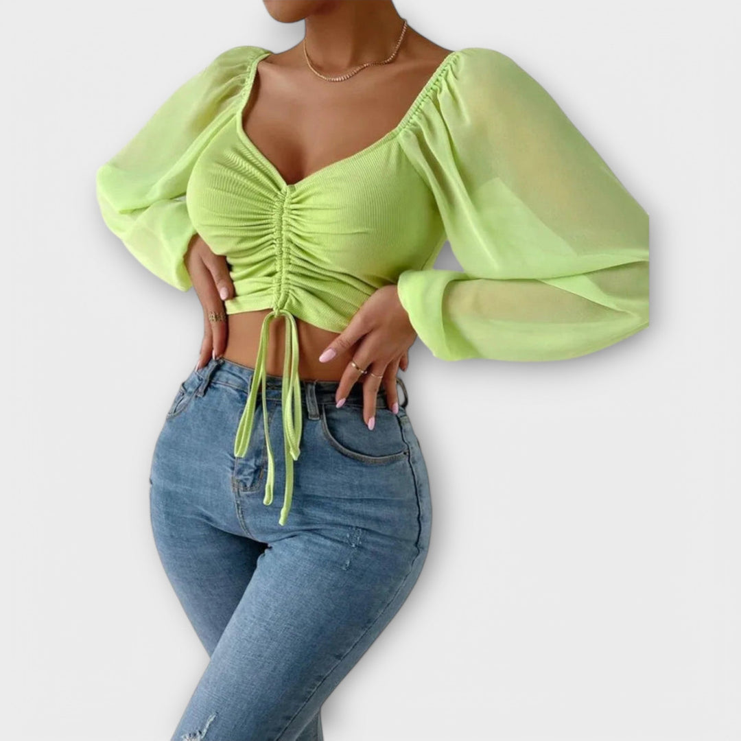 Jacqueline - Blusa color crema con estampado de rostros